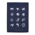 A blue cotton tea towel with white astrological signs printed on it, displayed flat.